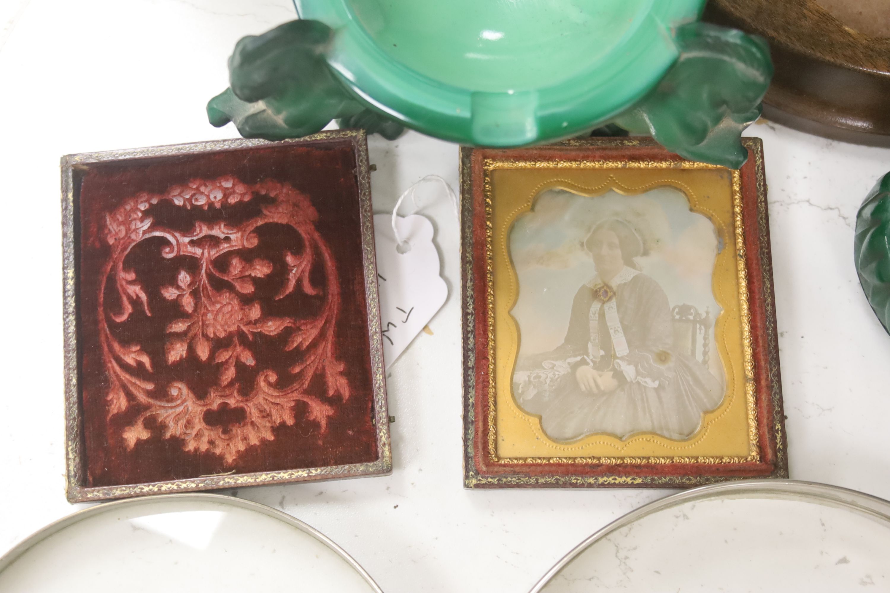 A French Art Deco green glass ashtray, a similar green glass Buddha, two magnifying glasses and a Daguerreotype portrait of a Victorian lady